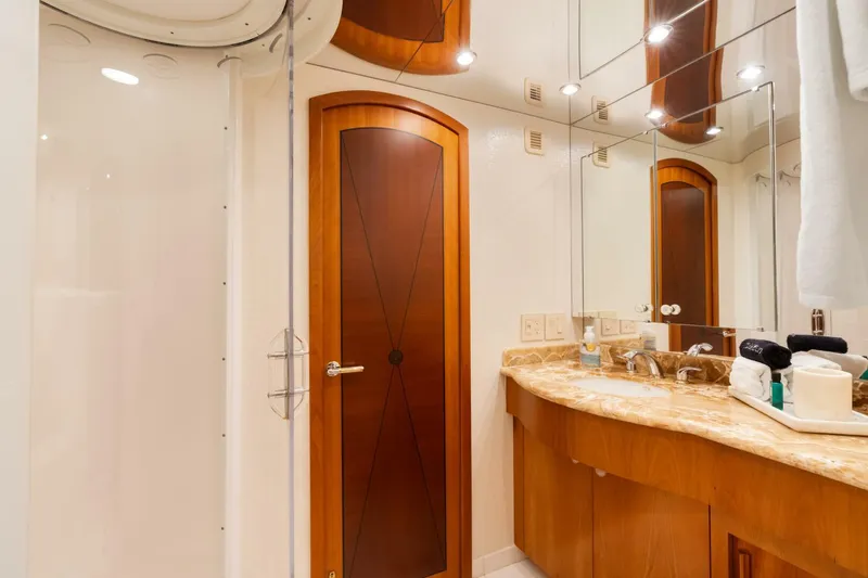 Magic Yacht Photos Pics Luxurious bathroom in 2005 Hatteras 100 Motor Yacht with elegant wood accents and marble countertop.