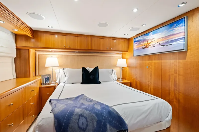Magic Yacht Photos Pics Luxurious bedroom interior of 2005 Hatteras 100 Motor Yacht with elegant wood paneling.