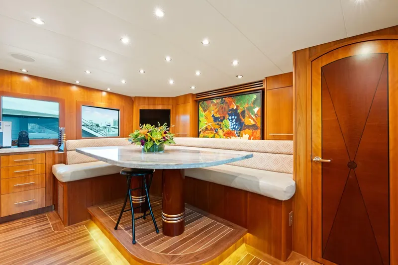 Magic Yacht Photos Pics Luxurious 2005 Hatteras 100 Motor Yacht interior with elegant wood finishes and vibrant artwork.