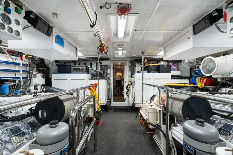 Magic Yacht Photos Pics Engine room of 2005 Hatteras 100 Motor Yacht, featuring advanced equipment and organized layout.