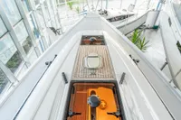 2023 Dehler 34 sailboat deck with sleek design and modern features in a showroom.