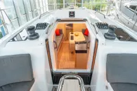 2023 Dehler 34 yacht interior with modern seating and wooden flooring.