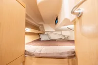 Cozy cabin interior of 2023 Dehler 34 yacht with comfortable bedding.