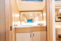 2023 Dehler 34 yacht interior bathroom with modern fixtures and wooden cabinetry.