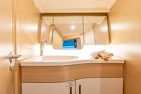 Modern bathroom interior of 2023 Dehler 34 yacht with sleek sink and mirror.