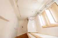 Interior of 2023 Dehler 34 yacht bathroom with modern fixtures and wooden accents.