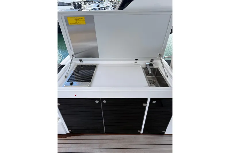  Yacht Photos Pics Outdoor kitchen on 2023 Ferretti Yachts 580, featuring grill and sink.