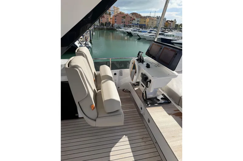  Yacht Photos Pics 2023 Ferretti Yachts 580 helm station with dual seats and navigation controls.