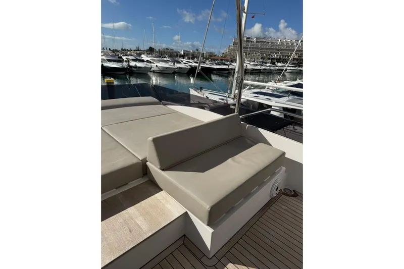  Yacht Photos Pics Luxurious seating area on 2023 Ferretti Yachts 580, docked at a marina.