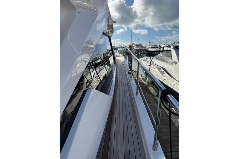  Yacht Photos Pics Side view of 2023 Ferretti Yachts 580 docked, showcasing sleek design and polished railings.
