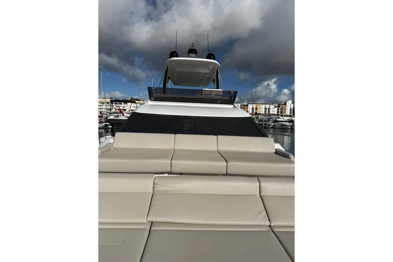  Yacht Photos Pics 2023 Ferretti Yachts 580, luxury yacht with cushioned seating, docked at marina.