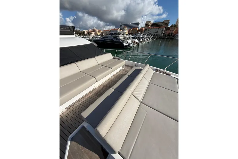  Yacht Photos Pics Luxurious 2023 Ferretti Yachts 580 with spacious deck seating in a scenic marina.