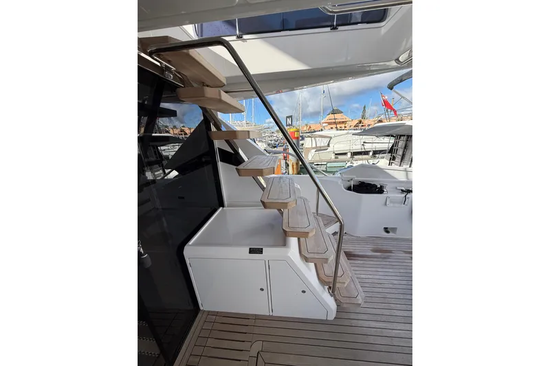  Yacht Photos Pics Staircase on 2023 Ferretti Yachts 580, leading to upper deck, docked in marina.
