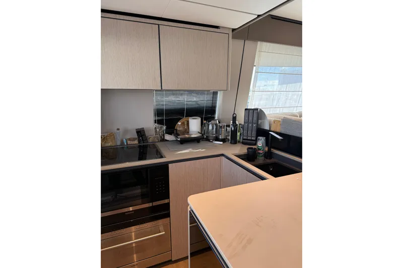  Yacht Photos Pics Modern kitchen interior on 2023 Ferretti Yachts 580, featuring sleek cabinetry and appliances.