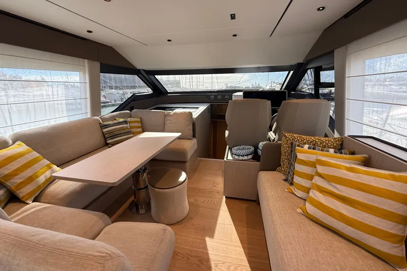  Yacht Photos Pics Luxurious interior of 2023 Ferretti Yachts 580 with elegant seating and striped cushions.