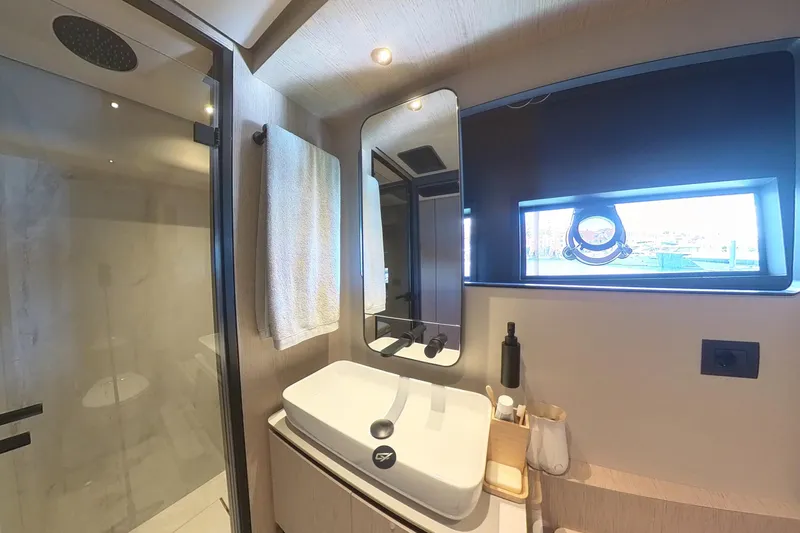  Yacht Photos Pics Luxurious bathroom interior of 2023 Ferretti Yachts 580 with modern fixtures and window view.