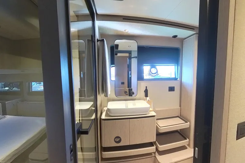  Yacht Photos Pics Luxurious bathroom interior of 2023 Ferretti Yachts 580 with modern fixtures and window.