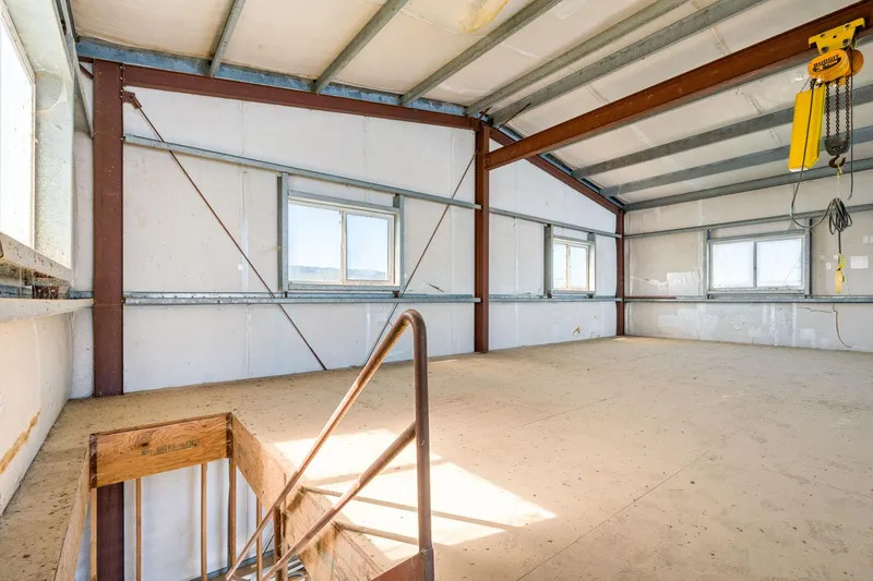  Yacht Photos Pics Spacious interior of 1985 Custom Larson Boathouse with metal beams and windows.