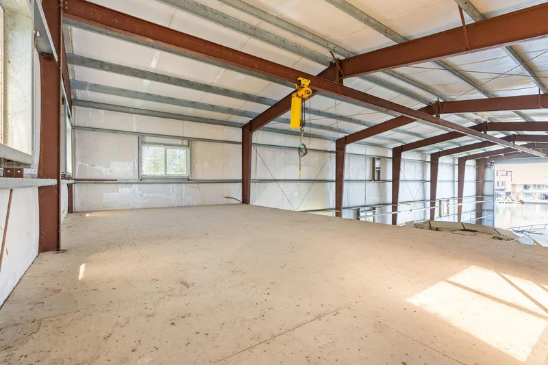  Yacht Photos Pics Spacious interior of 1985 Custom Larson Boathouse with metal beams and large windows.