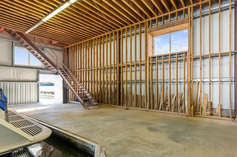  Yacht Photos Pics Spacious 1985 Custom Larson Boathouse interior with wooden beams and staircase.