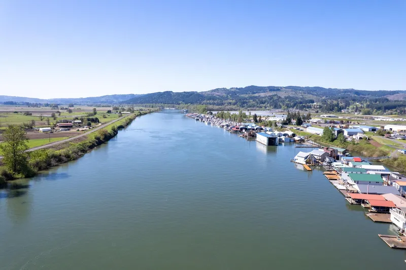  Yacht Photos Pics Aerial view of a river with boathouses, including a 1985 Custom Larson Boathouse.