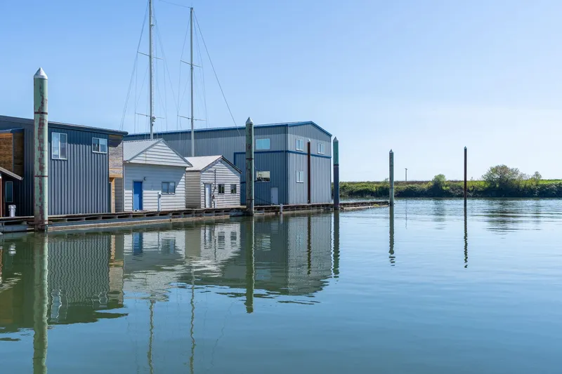  Yacht Photos Pics Boathouse on calm water, clear sky, Custom Larson Boathouse, 1985.