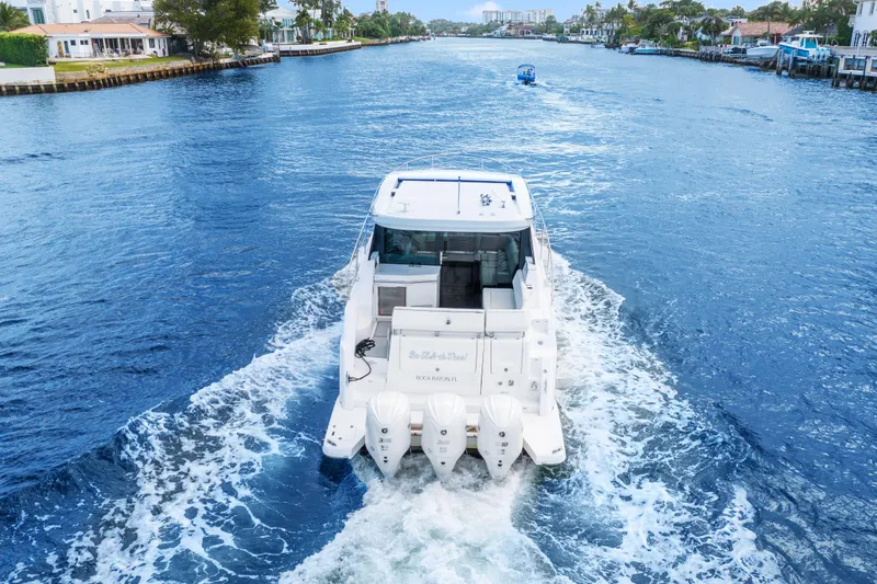  Yacht Photos Pics 2024 Regal 38 XO yacht cruising on a scenic waterway.