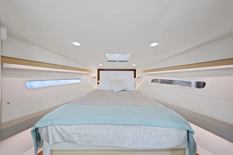  Yacht Photos Pics Luxurious interior cabin of 2024 Regal 38 XO yacht with comfortable bedding.