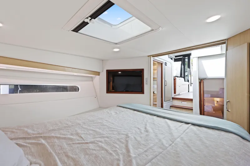  Yacht Photos Pics Luxurious interior of 2024 Regal 38 XO yacht with modern bedroom and skylight.
