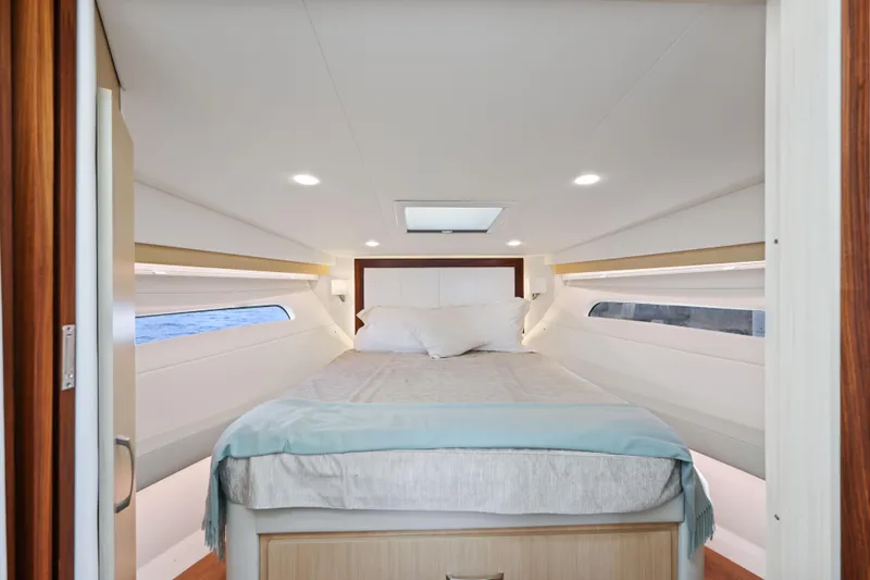  Yacht Photos Pics Luxurious cabin interior of 2024 Regal 38 XO yacht with cozy bed and modern design.