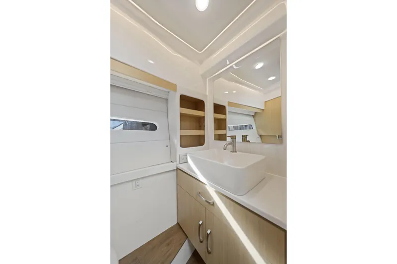  Yacht Photos Pics Luxurious bathroom interior of 2024 Regal 38 XO yacht with modern sink and mirror.