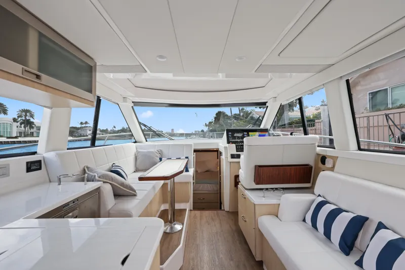  Yacht Photos Pics Luxurious interior of 2024 Regal 38 XO yacht with modern seating and panoramic windows.