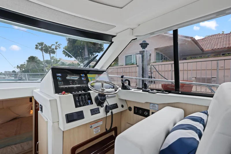  Yacht Photos Pics 2024 Regal 38 XO yacht interior with modern helm and navigation controls.