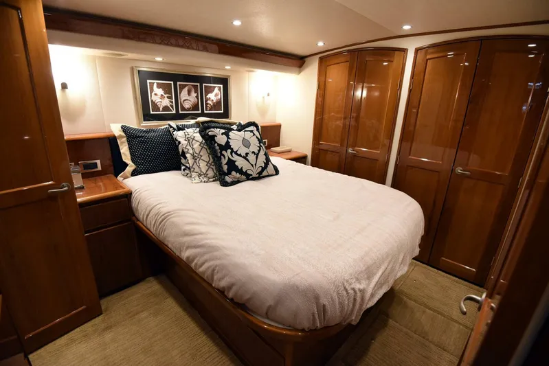 Crank It Up Yacht Photos Pics Luxurious bedroom interior of 2014 Viking 62 Convertible yacht with elegant wood finishes.