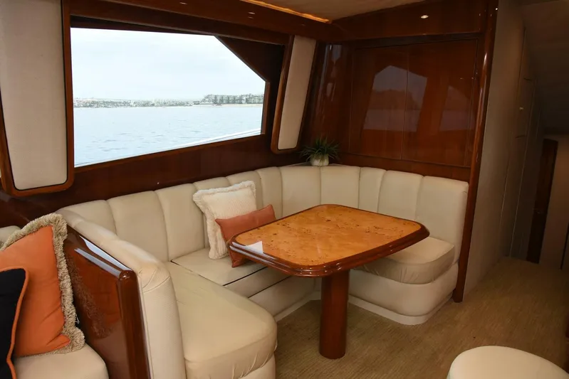 Crank It Up Yacht Photos Pics Luxurious interior of 2014 Viking 62 Convertible yacht with plush seating and wooden table.