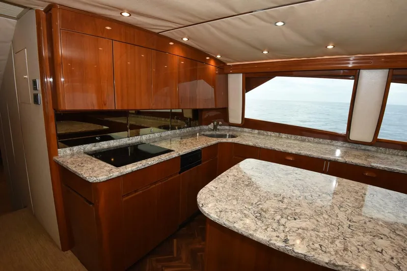 Crank It Up Yacht Photos Pics Luxurious kitchen interior of 2014 Viking 62 Convertible yacht with granite countertops.