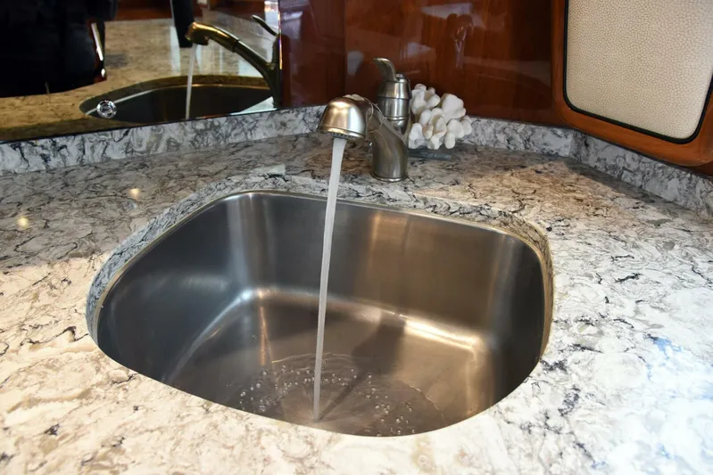 Crank It Up Yacht Photos Pics Stainless steel sink with running water in 2014 Viking 62 Convertible yacht kitchen.