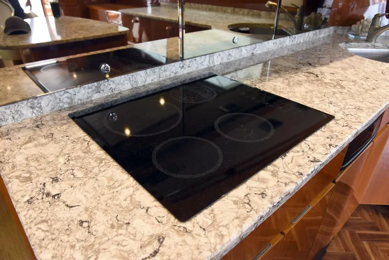 Crank It Up Yacht Photos Pics Modern kitchen cooktop on marble countertop in 2014 Viking 62 Convertible yacht.
