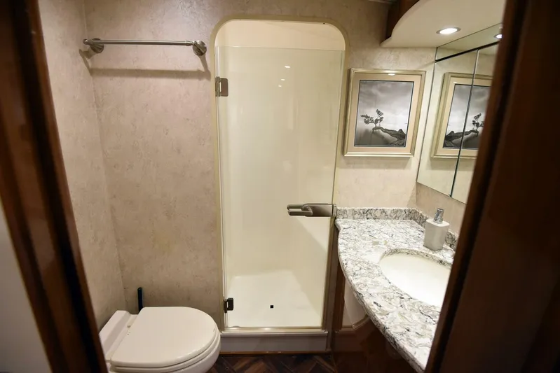 Crank It Up Yacht Photos Pics Bathroom in 2014 Viking 62 Convertible yacht with shower, toilet, and granite countertop.