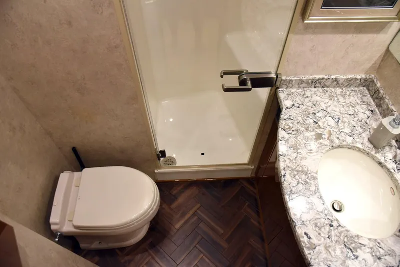 Crank It Up Yacht Photos Pics Bathroom in 2014 Viking 62 Convertible yacht with shower, toilet, and marble countertop sink.