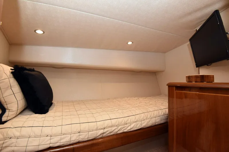 Crank It Up Yacht Photos Pics Cozy cabin interior of 2014 Viking 62 Convertible yacht with bed and TV.