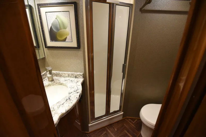 Crank It Up Yacht Photos Pics 2014 Viking 62 Convertible yacht bathroom with shower, sink, and toilet.