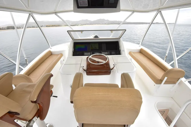 Crank It Up Yacht Photos Pics Flybridge of 2014 Viking 62 Convertible yacht with beige seating and modern controls.