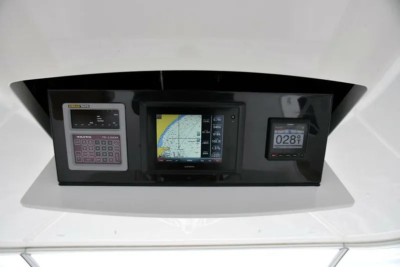 Crank It Up Yacht Photos Pics Control panel of a 2014 Viking 62 Convertible yacht with navigation and monitoring systems.