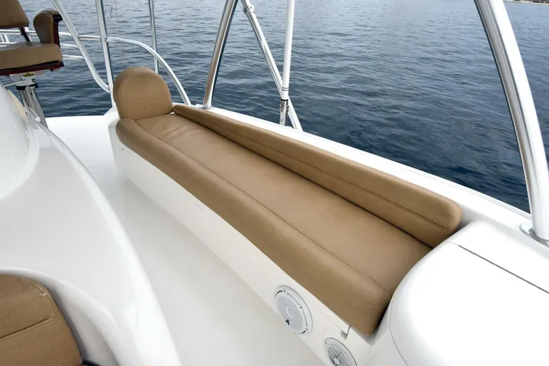 Crank It Up Yacht Photos Pics 2014 Viking 62 Convertible boat with tan cushioned seating on deck.