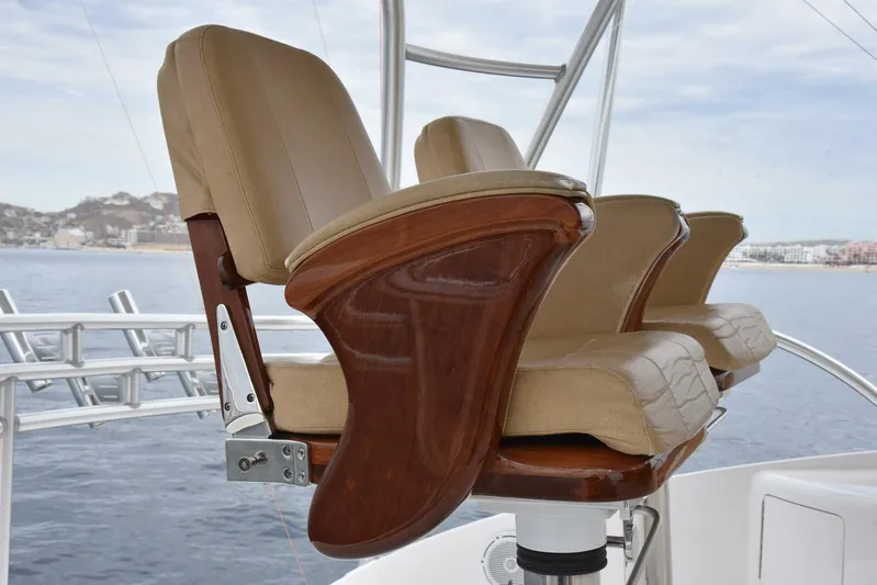 Crank It Up Yacht Photos Pics Luxurious seating on the 2014 Viking 62 Convertible yacht, featuring elegant wooden armrests.