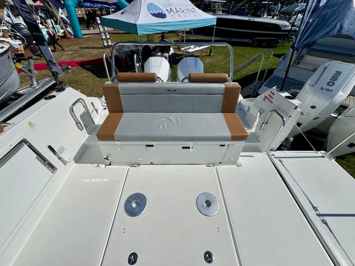  Yacht Photos Pics 2024 Beneteau Flyer 9 SPACEdeck boat with spacious seating and modern design at a marine exhibition.