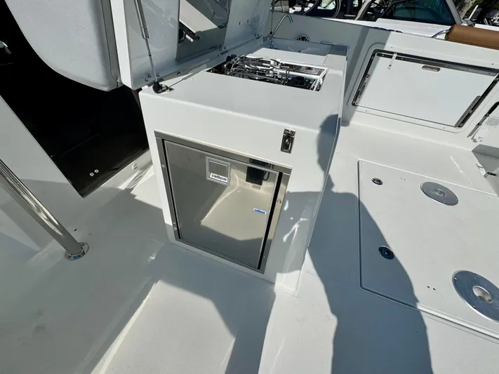  Yacht Photos Pics 2024 Beneteau Flyer 9 SPACEdeck boat interior with compact kitchenette and storage.