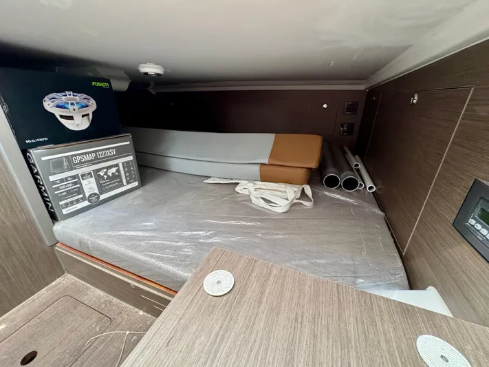  Yacht Photos Pics 2024 Beneteau Flyer 9 SPACEdeck cabin interior with GPS equipment and storage space.