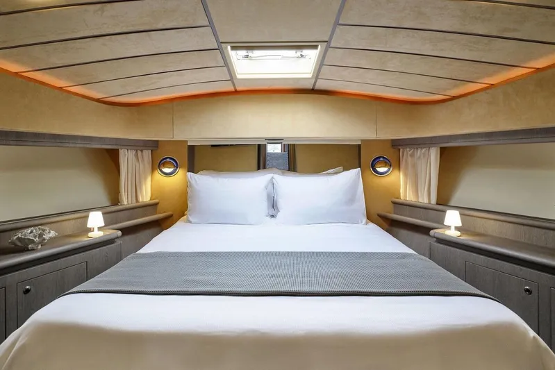 Miren Yacht Photos Pics Luxurious bedroom interior of 2000 Ferretti Yachts 68 with elegant lighting and cozy bedding.